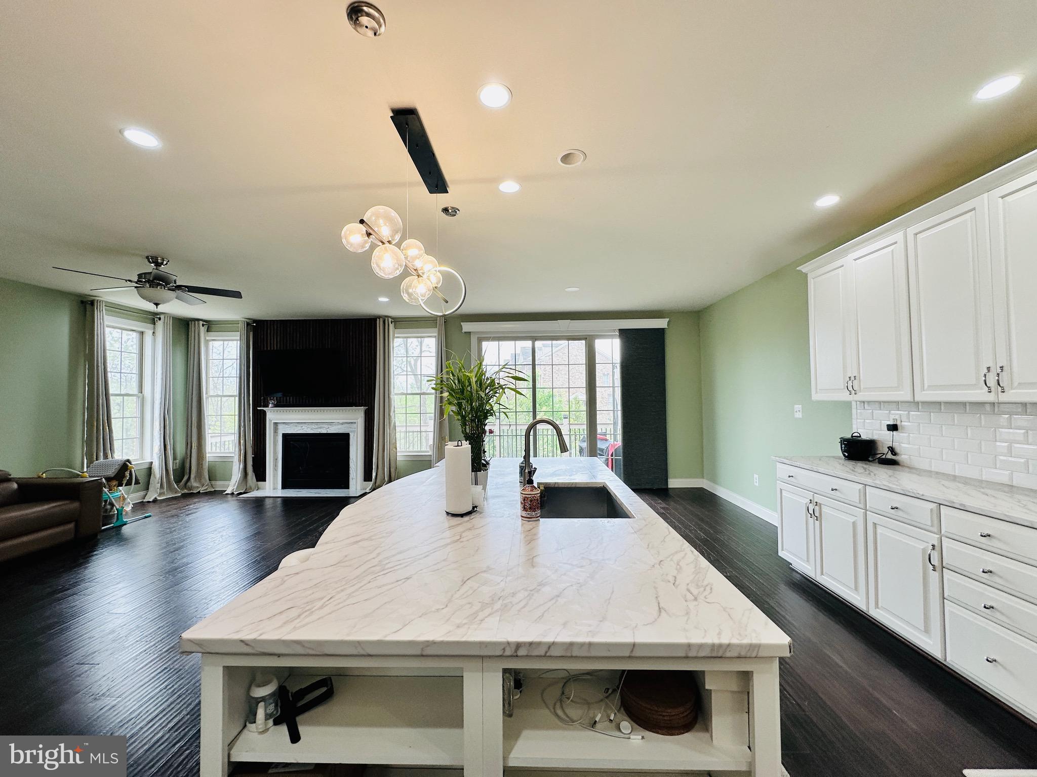 22611 Windsor Locks Square Ashburn, VA 20148 - Photo 10 of 53 a kitchen with a stove a sink and a fireplace
