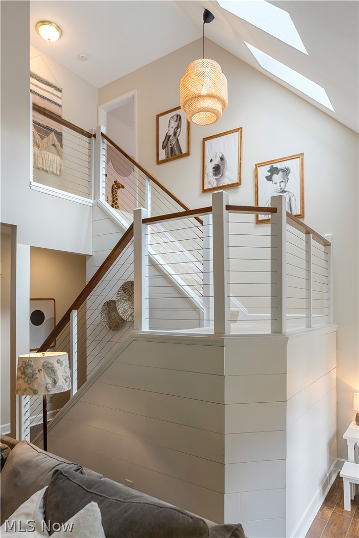 3228 Bancroft Road Akron, OH 44333 - Photo 21 of 50 Stairway featuring high vaulted ceiling, hardwood / wood-style flooring, and a skylight