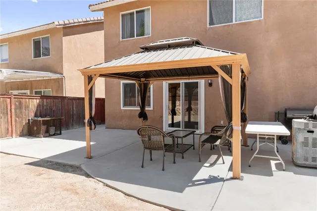 an aerial view of a house with table and chairs