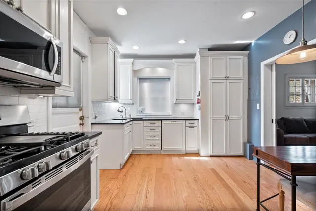a kitchen with stainless steel appliances granite countertop a stove and a refrigerator
