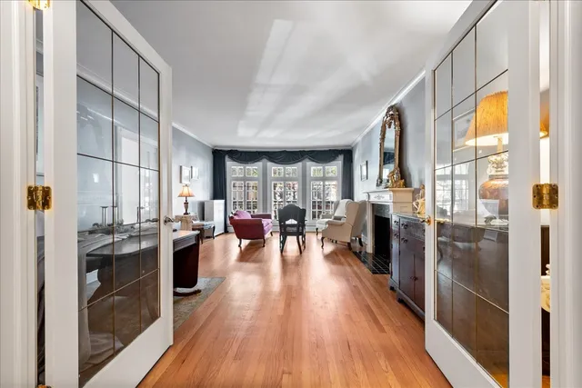 a living room with stainless steel appliances granite countertop a stove and wooden floor