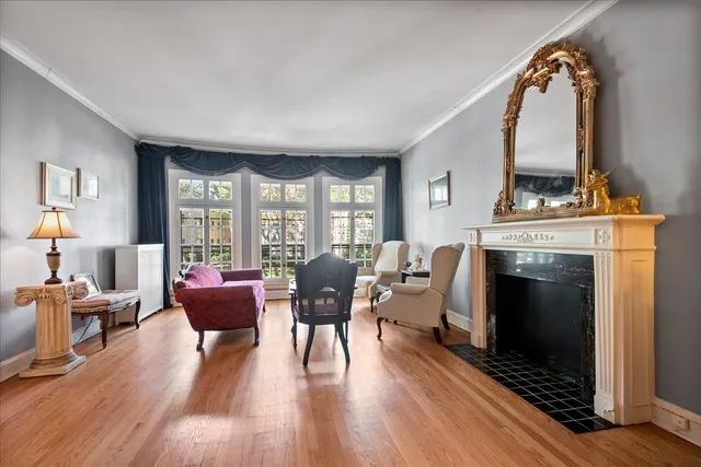 a view of a livingroom with furniture a fireplace and wooden floor