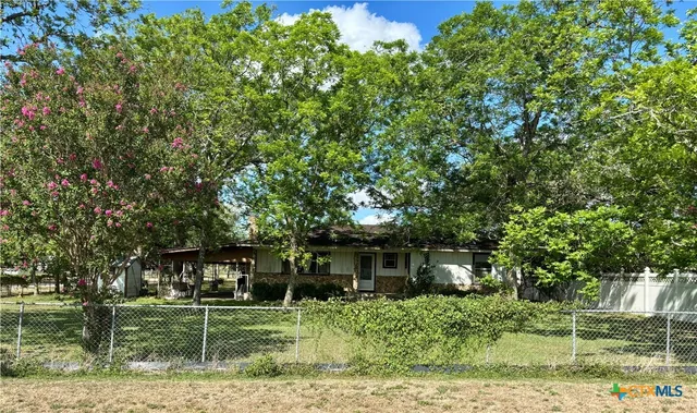 front view of a house with a tree