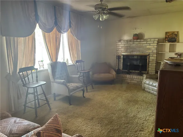 a living room with furniture a window and a fireplace