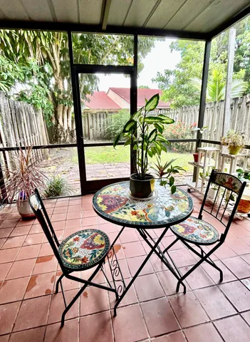 a view of a chairs and table in patio