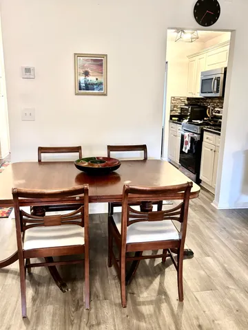 a view of a dining room with furniture and wooden floor
