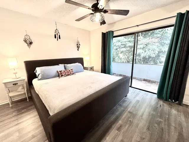 a large bed sitting in a bedroom next to a window