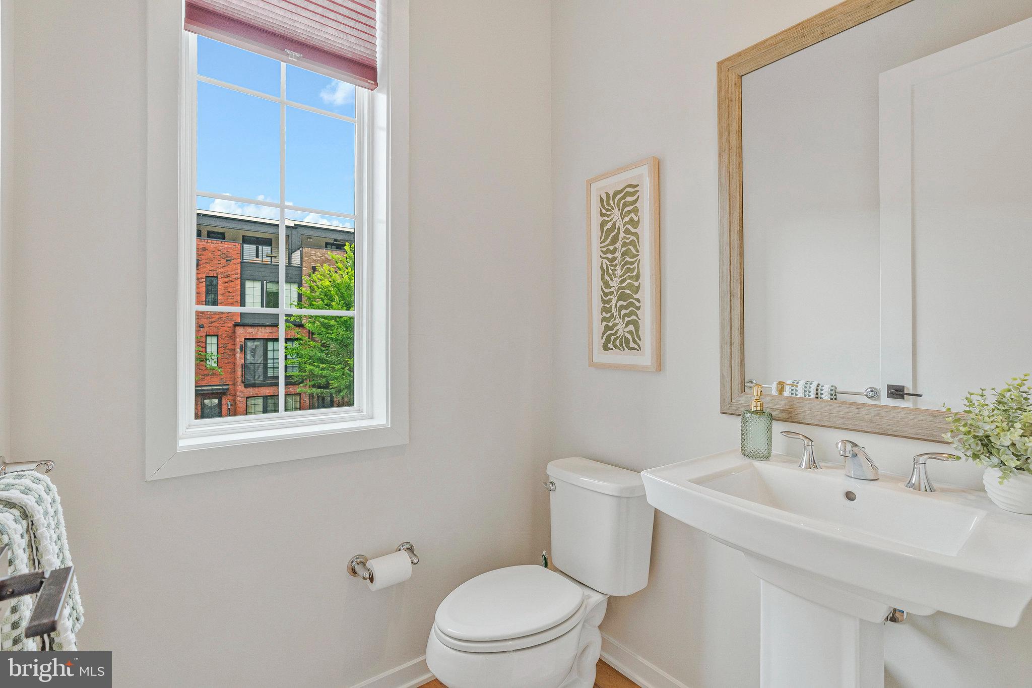 11724 Paysons Way Reston, VA 20191 - Photo 14 of 41 a bathroom with a toilet a sink and a mirror