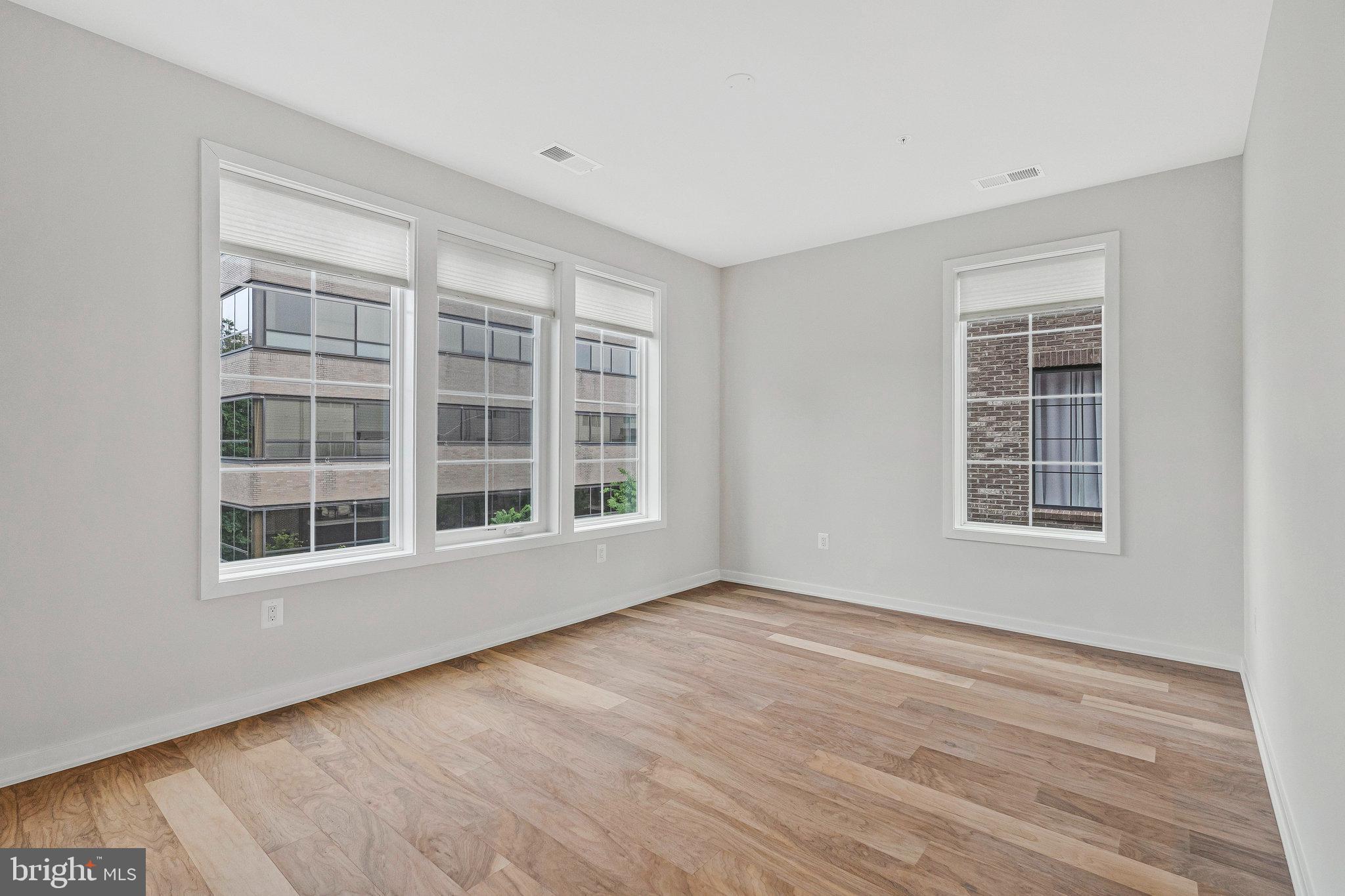 11724 Paysons Way Reston, VA 20191 - Photo 21 of 41 a view of an empty room with wooden floor and a window