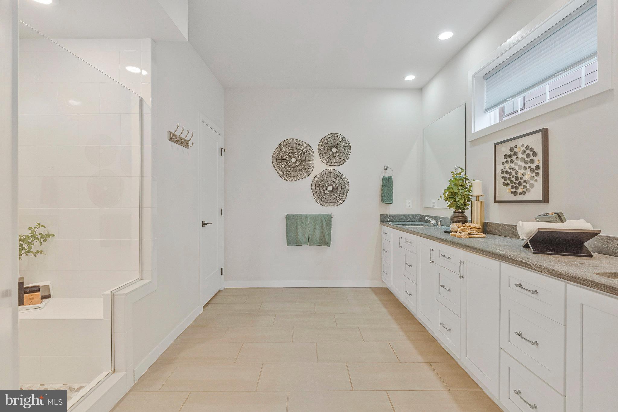 11724 Paysons Way Reston, VA 20191 - Photo 27 of 41 a bathroom with a granite countertop sink a mirror and a shower