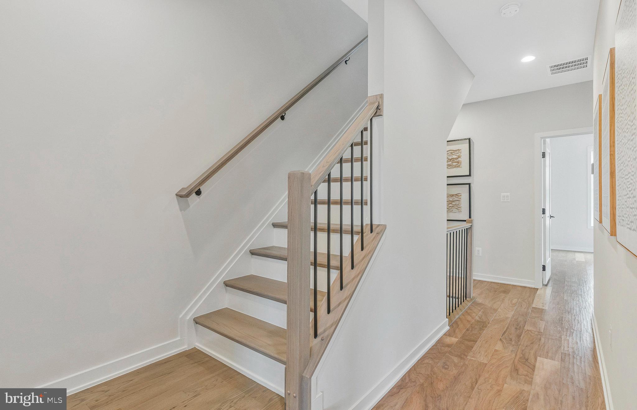 11724 Paysons Way Reston, VA 20191 - Photo 31 of 41 a view of staircase with wooden floor and white walls