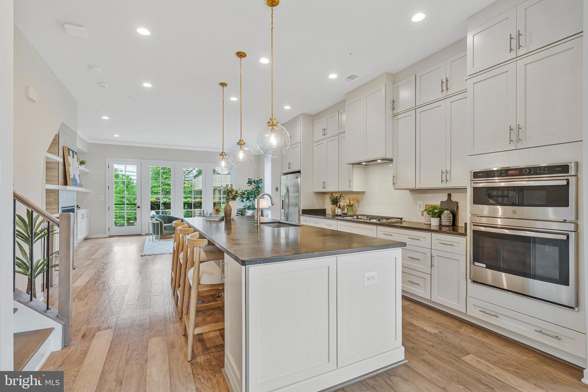 11724 Paysons Way Reston, VA 20191 - Photo 7 of 41 a kitchen with stainless steel appliances granite countertop a stove a sink a oven and a refrigerator with white cabinets