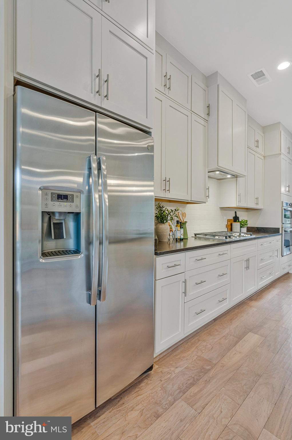 11724 Paysons Way Reston, VA 20191 - Photo 9 of 41 a kitchen with cabinets and a refrigerator