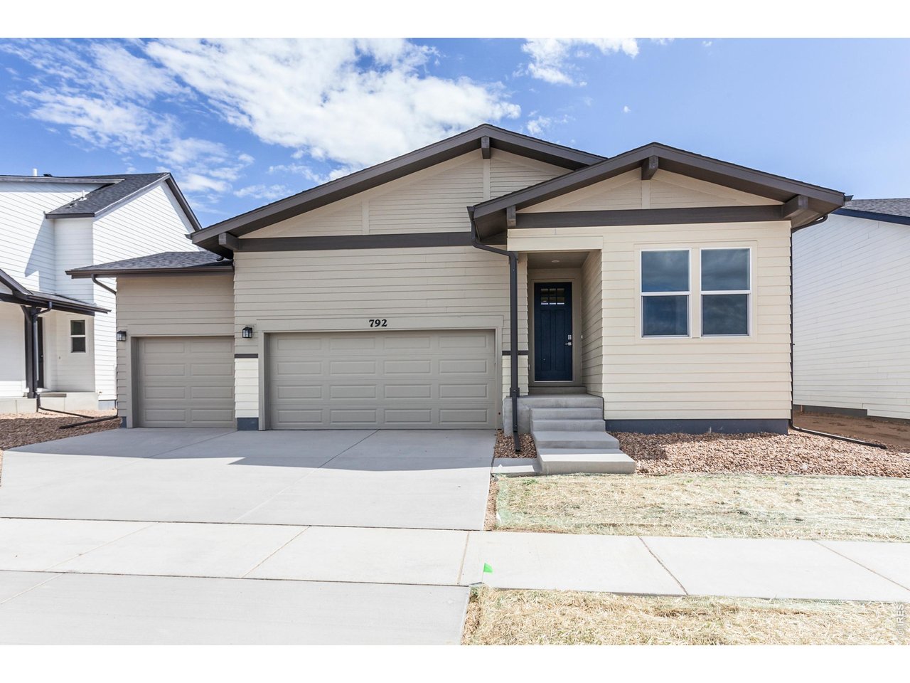792 Chatter Road Windsor, CO 80550 - Photo 2 of 49 a front view of a house with a garage