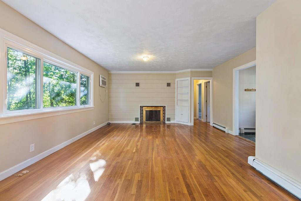 23 Purgatory Road Northbridge, MA 01588 - Photo 7 of 20 a view of empty room with wooden floor and fireplace