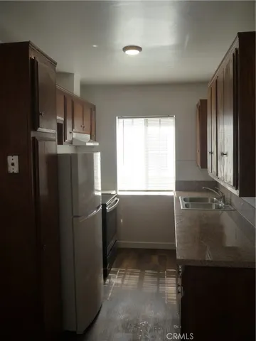 a kitchen with granite countertop a sink and cabinets