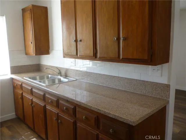 a kitchen with a sink and a refrigerator