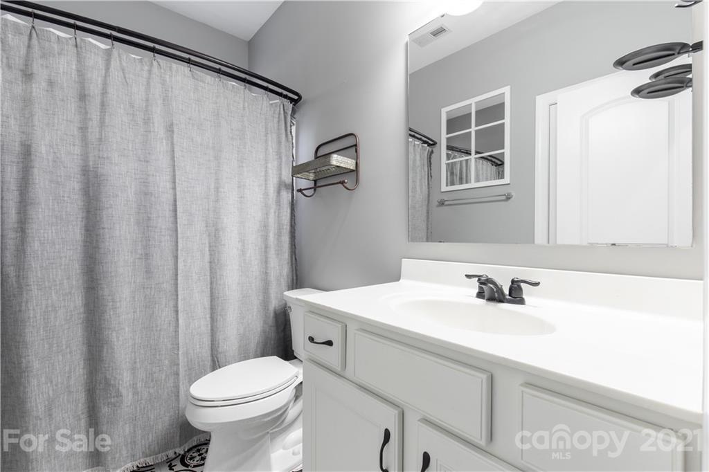 86512 Arrington Road Lancaster, SC 29720 - Photo 15 of 31 a bathroom with a sink a toilet and shower curtain