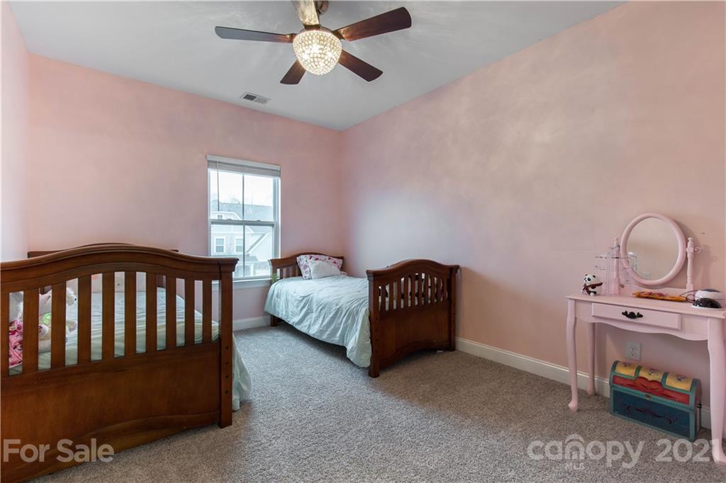 86512 Arrington Road Lancaster, SC 29720 - Photo 22 of 31 a bedroom with bed and a chandelier