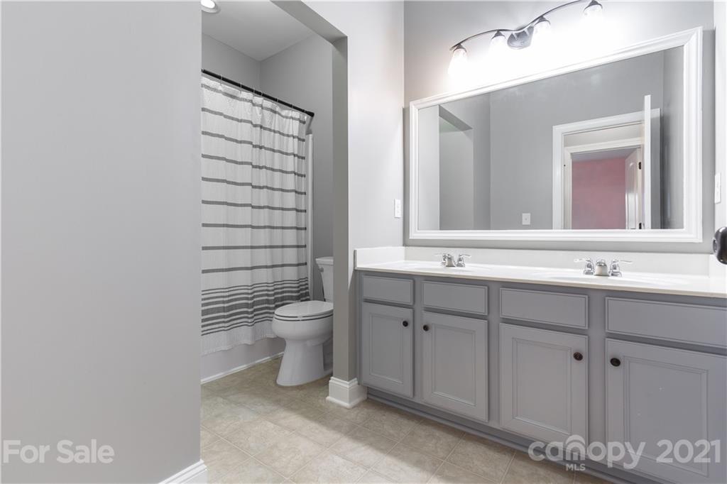 86512 Arrington Road Lancaster, SC 29720 - Photo 23 of 31 a bathroom with a sink a toilet and mirror
