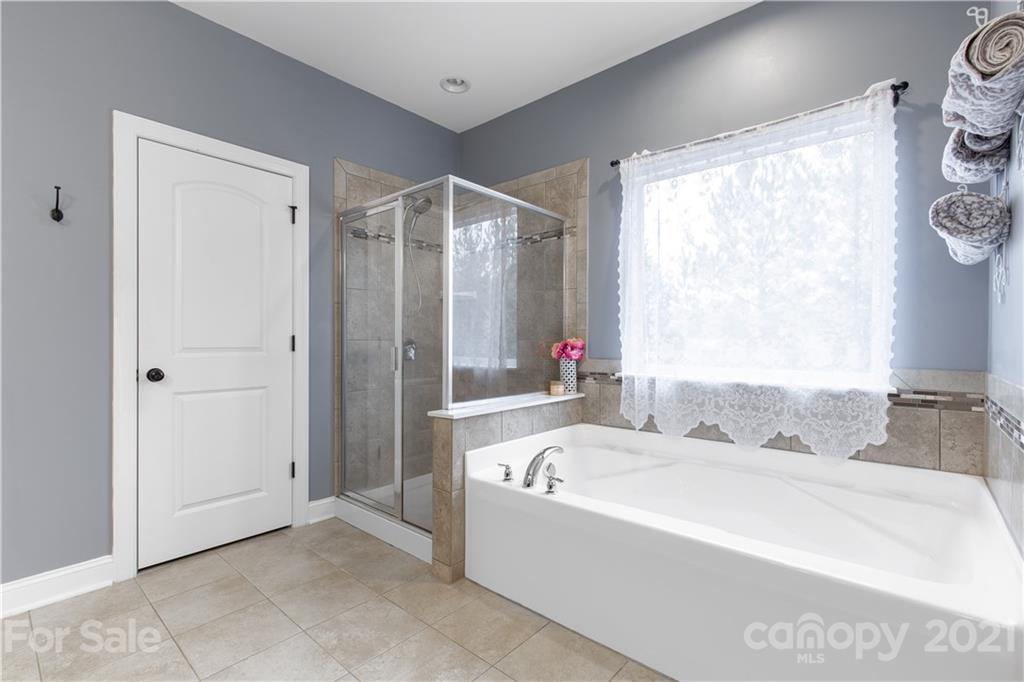 86512 Arrington Road Lancaster, SC 29720 - Photo 28 of 31 a white bath tub sitting next to a small bathroom