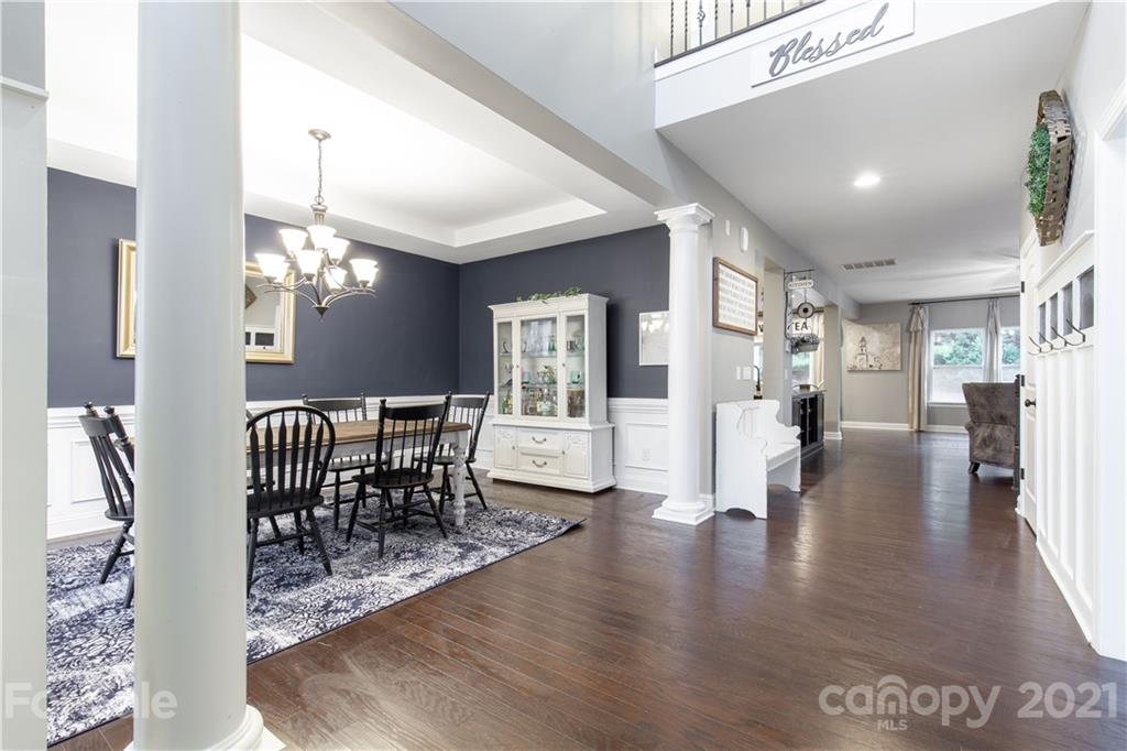 86512 Arrington Road Lancaster, SC 29720 - Photo 5 of 31 a view of a dining room with furniture a chandelier and wooden floor