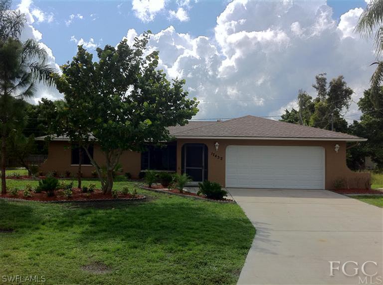 17432 Lebanon Road Fort Myers, FL 33967 - Photo 1 of 20 a front view of a house with a garden and yard