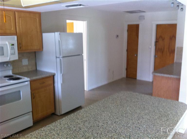 17432 Lebanon Road Fort Myers, FL 33967 - Photo 12 of 20 a kitchen with a refrigerator and cabinets