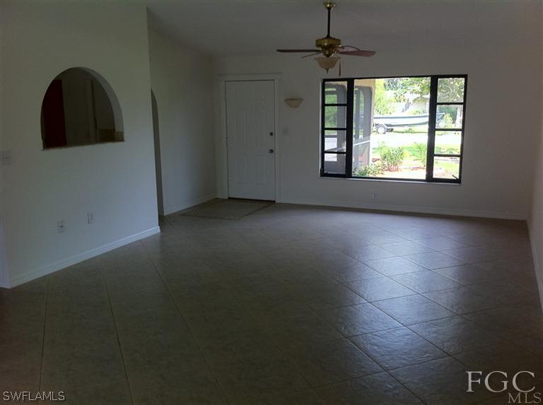 17432 Lebanon Road Fort Myers, FL 33967 - Photo 4 of 20 an empty room with windows and natural light