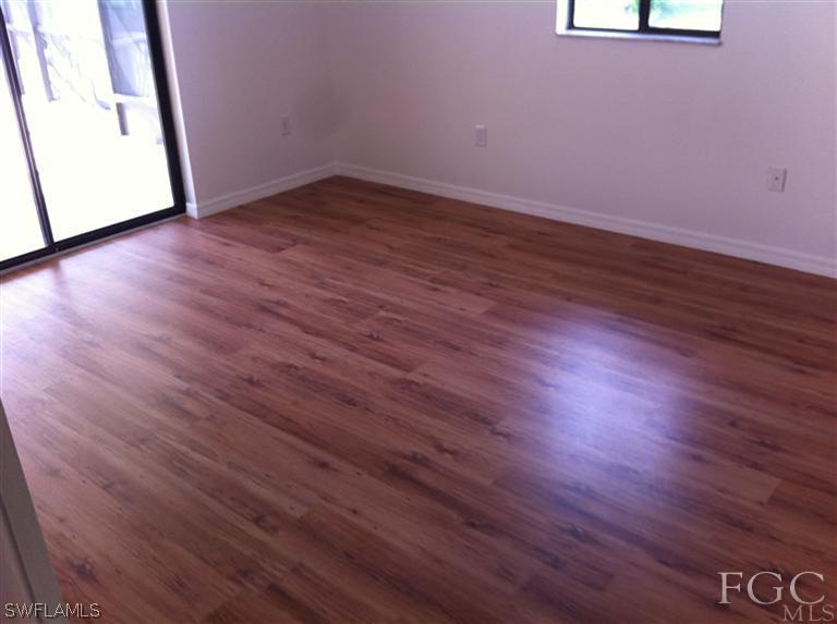 17432 Lebanon Road Fort Myers, FL 33967 - Photo 10 of 20 an empty room with wooden floor and windows
