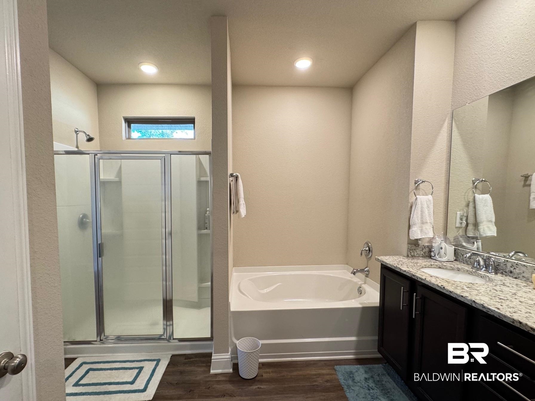 1346 Kairos Loop Foley, AL 36535 - Photo 14 of 40 Bathroom with hardwood / wood-style floors, vanity, and independent shower and bath