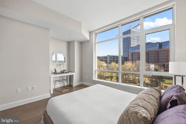 a bedroom with a large bed and a window