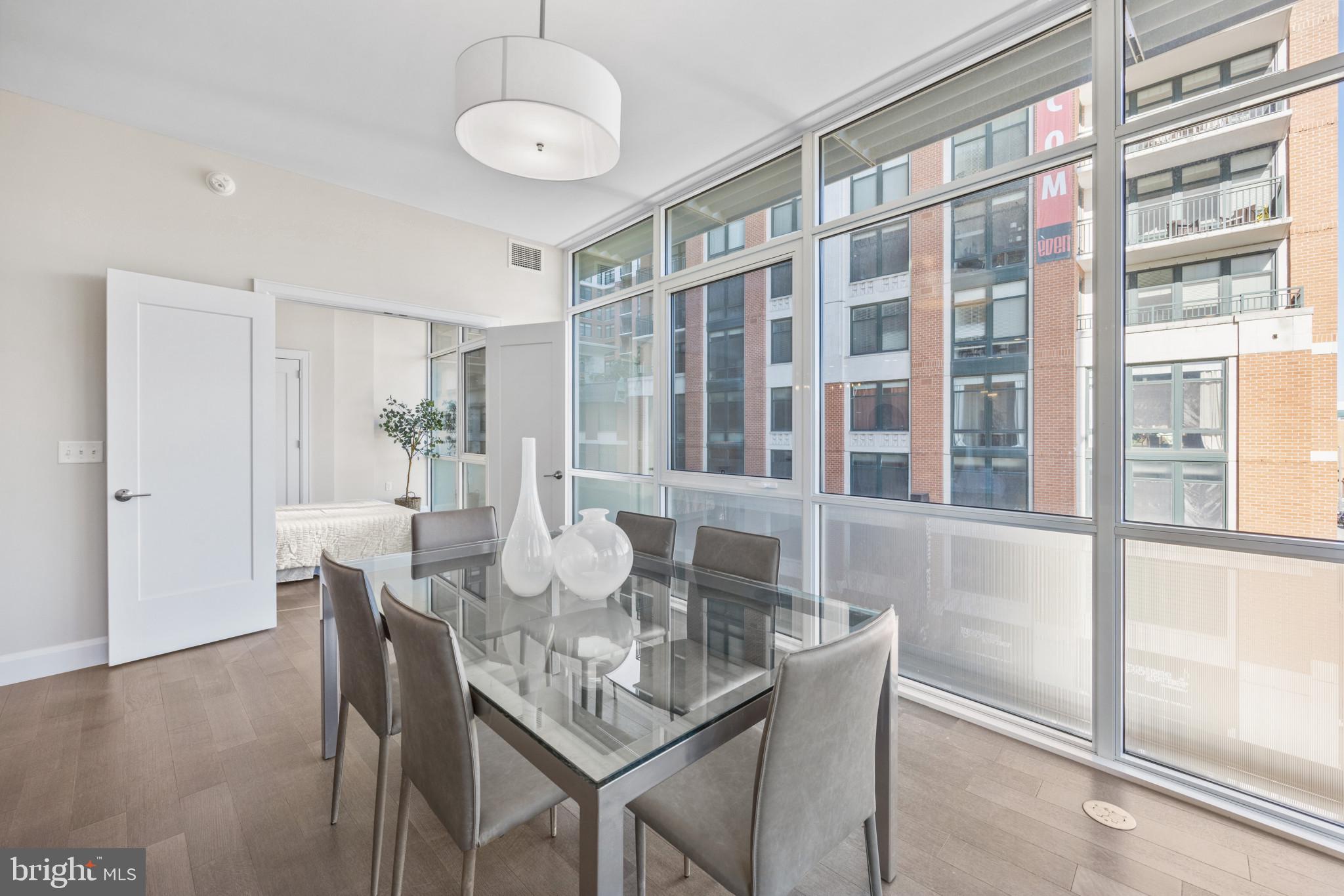 1330 Lancaster Street, Unit C601 Baltimore, MD 21231 - Photo 8 of 32 a view of a dining room with furniture window and wooden floor