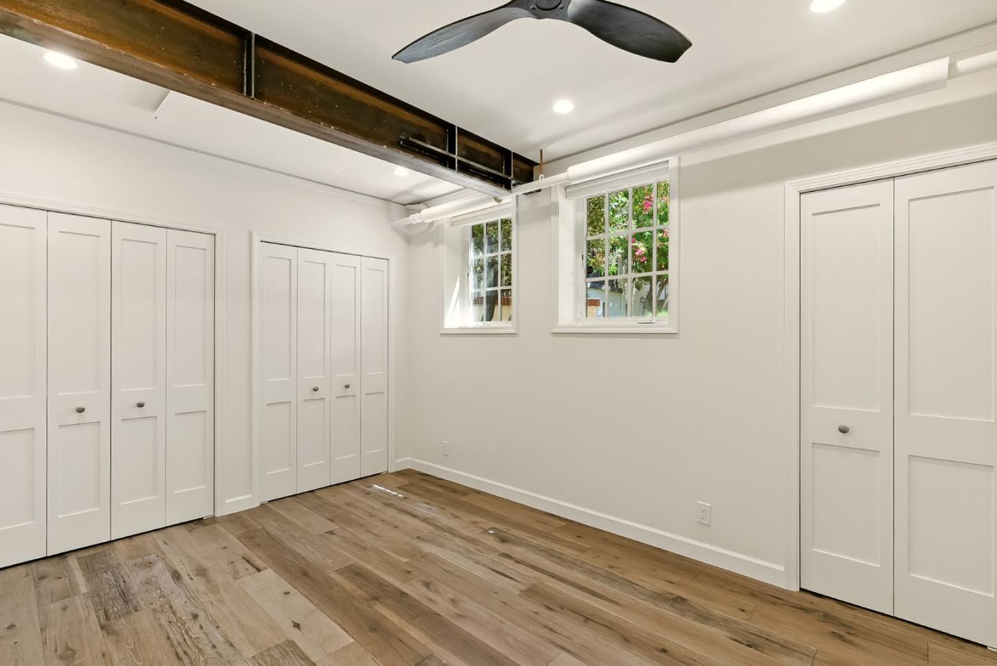 212 Eaton Road, Unit 1 San Mateo, CA 94402 - Photo 6 of 14 a view of an empty room with wooden floor and a window