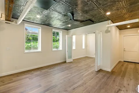 a kitchen with kitchen island a sink stove and wooden floor