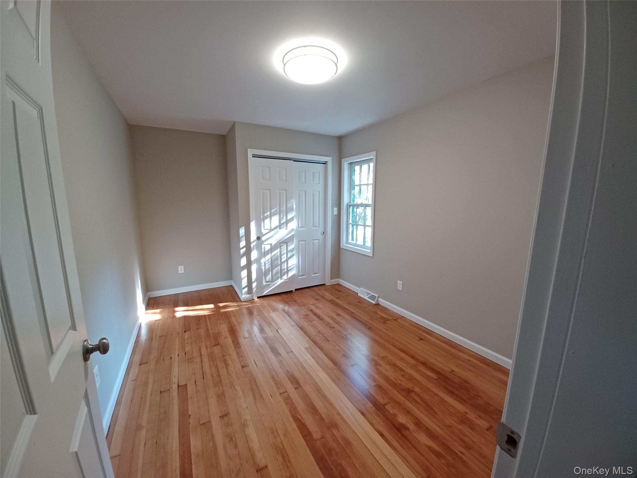 151 Airport Road Bethel, NY 12762 - Photo 15 of 19 a view of an empty room with wooden floor and a window