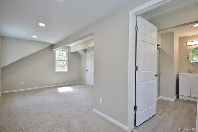 a view of an empty room and closet area