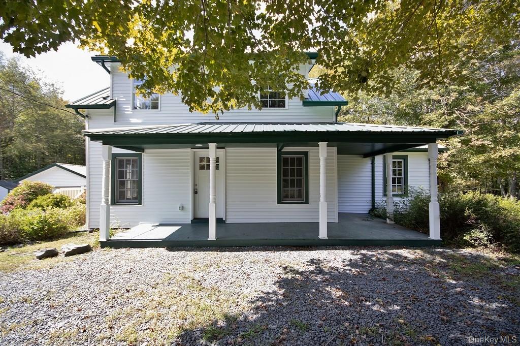 151 Airport Road Bethel, NY 12762 - Photo 2 of 19 a front view of a house with a yard and garage