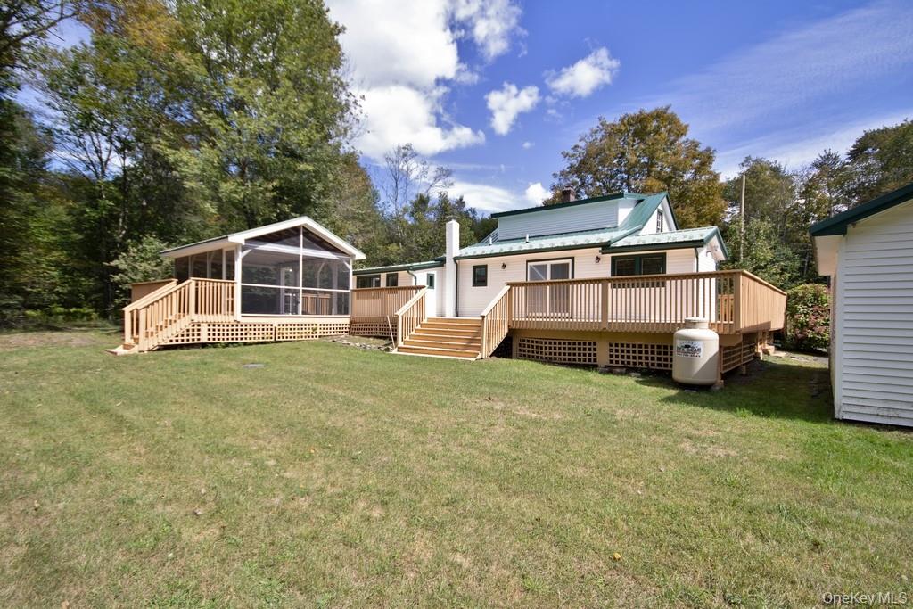 151 Airport Road Bethel, NY 12762 - Photo 4 of 19 a view of a house with a yard and sitting area