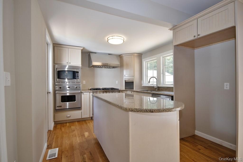 151 Airport Road Bethel, NY 12762 - Photo 8 of 19 a kitchen with stainless steel appliances granite countertop a sink stove and refrigerator