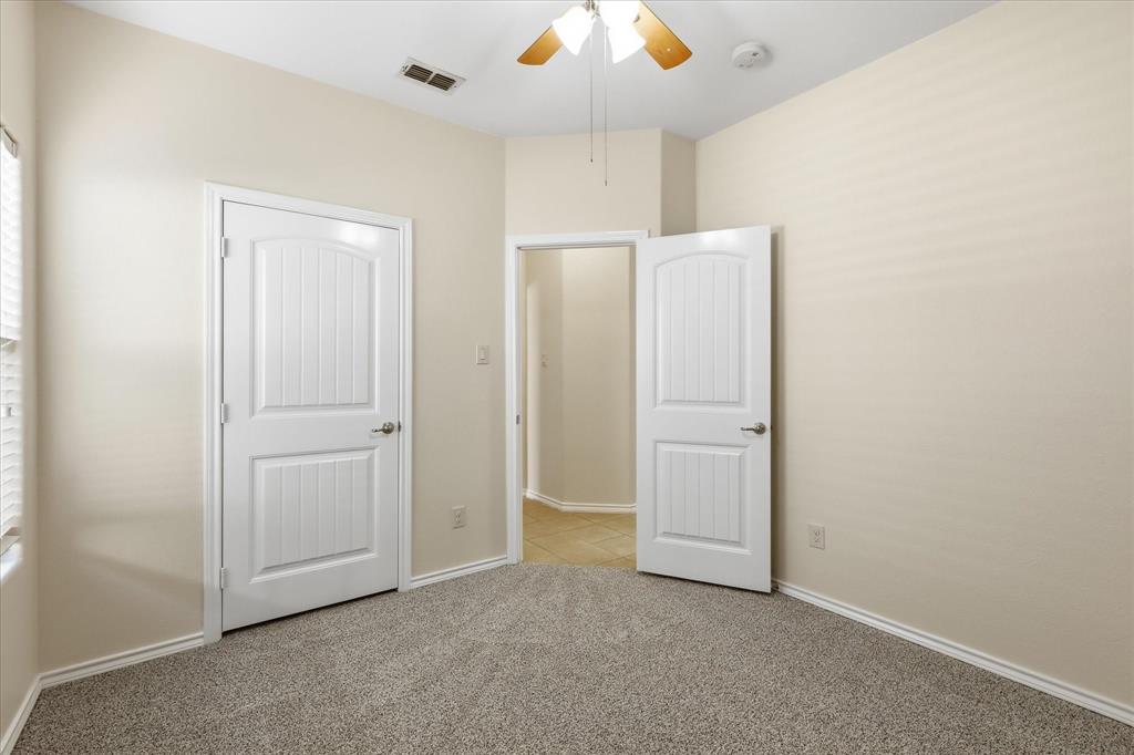 720 Rio Bravo Drive Fort Worth, TX 76052 - Photo 27 of 38 Carpeted room with vaulted ceiling and a ceiling fan