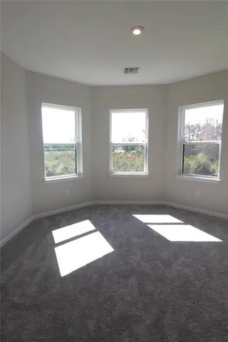 an empty room with closet and a bathroom