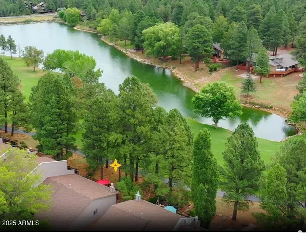 an aerial view of residential house with outdoor space and lake view