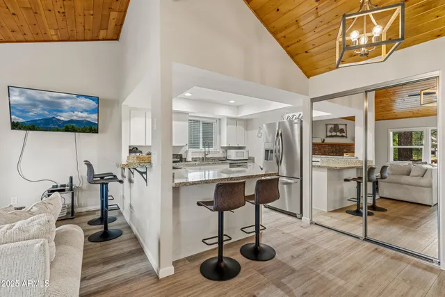 a kitchen with granite countertop white cabinets and appliances