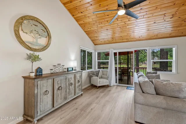 a living room with furniture a window and a chandelier