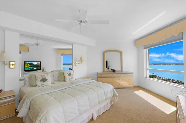 a bedroom with a large bed and a chandelier