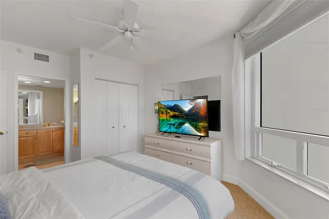 a bedroom with bed and a flat screen tv