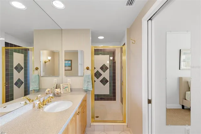 a bathroom with a sink tub shower and a mirror