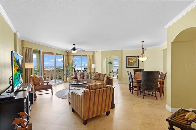 a living room with furniture and a chandelier