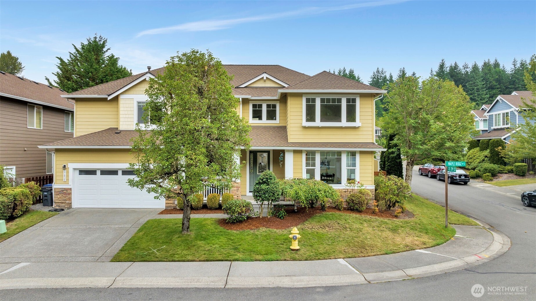 27836 Maple Ridge Way Southeast Maple Valley, WA 98038 - Photo 1 of 1 a front view of a house with a yard and garage